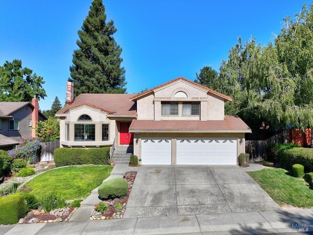 view of front of property with a garage and a front lawn