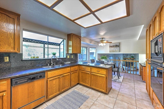 kitchen featuring backsplash, kitchen peninsula, sink, and black appliances