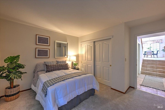 bedroom featuring light carpet and a closet