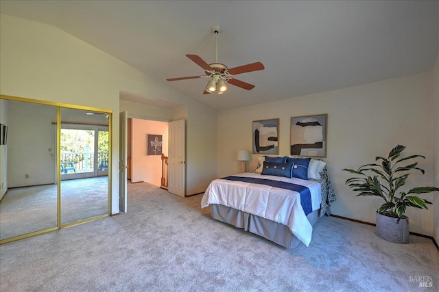 carpeted bedroom featuring ceiling fan, lofted ceiling, and a closet