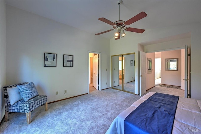 carpeted bedroom featuring ceiling fan, vaulted ceiling, and a closet