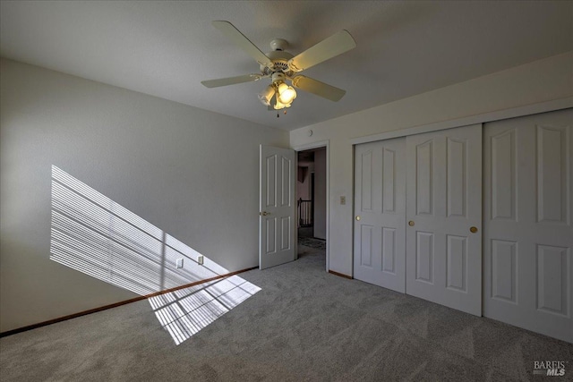 unfurnished bedroom with light carpet, a closet, and ceiling fan