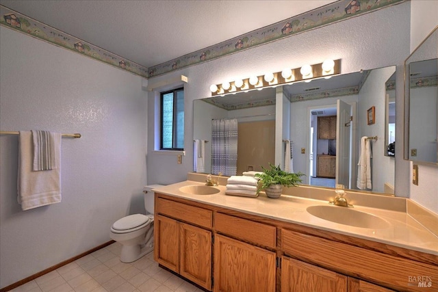 bathroom with a shower with shower curtain, vanity, and toilet