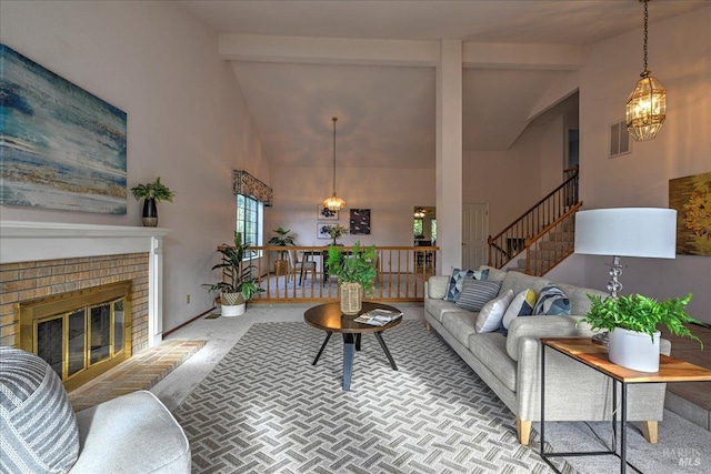 living room with a fireplace, beamed ceiling, light colored carpet, and high vaulted ceiling