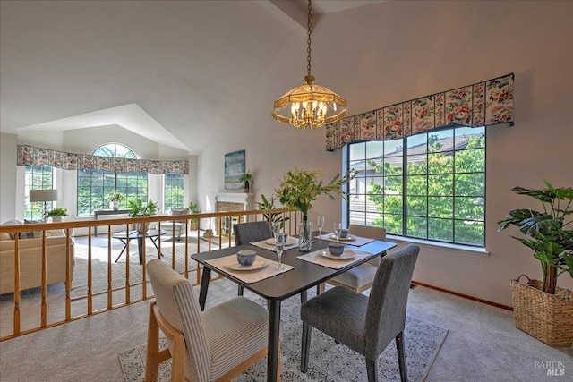 dining area with light carpet, high vaulted ceiling, and an inviting chandelier