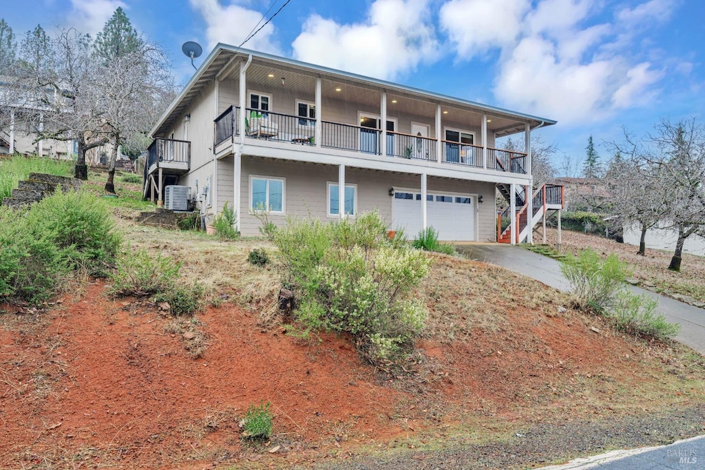 view of front of house featuring cooling unit and a garage