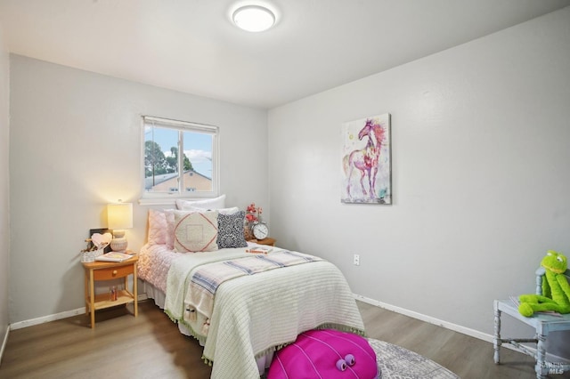 bedroom with dark hardwood / wood-style floors