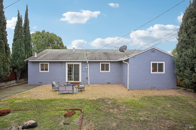 back of property with a patio area, a yard, and an outdoor hangout area