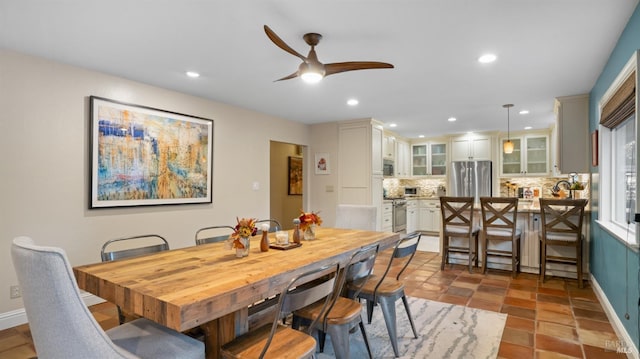 dining room with ceiling fan and light tile patterned floors