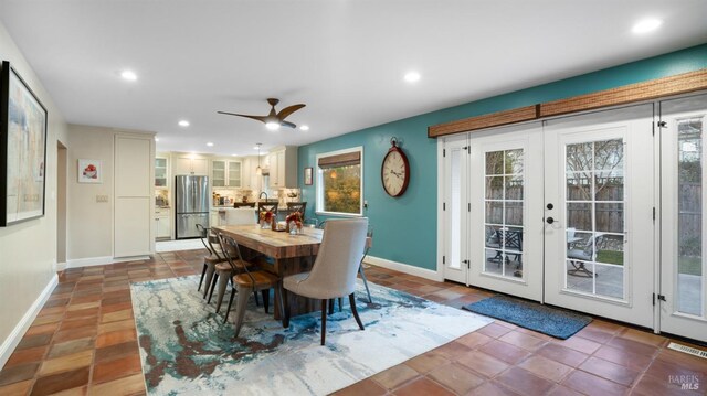 tiled dining room featuring french doors and ceiling fan