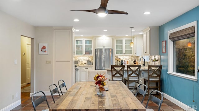 dining room with baseboards, a ceiling fan, and recessed lighting