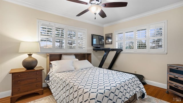 bedroom featuring crown molding, hardwood / wood-style floors, and ceiling fan