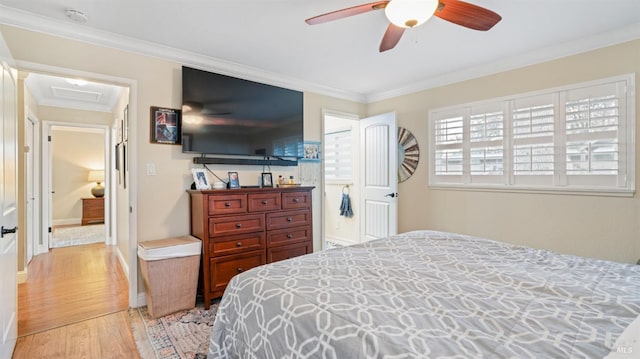 bedroom featuring ornamental molding, ceiling fan, and light hardwood / wood-style floors