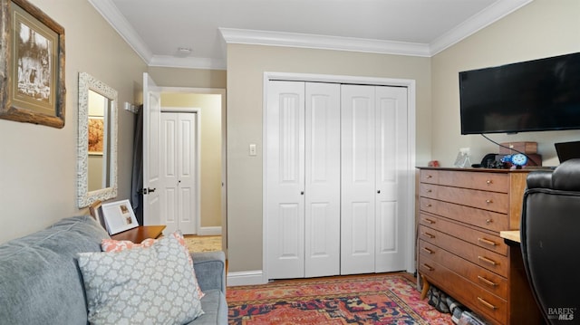 bedroom with crown molding and a closet