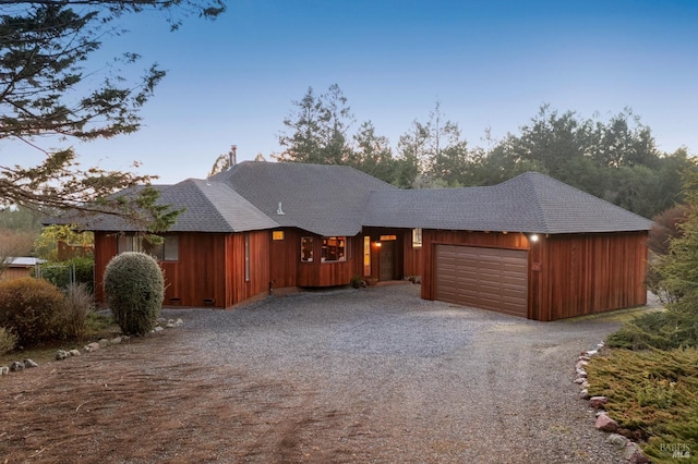 view of front of property with a garage, roof with shingles, gravel driveway, crawl space, and board and batten siding