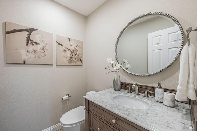 bathroom featuring toilet and vanity