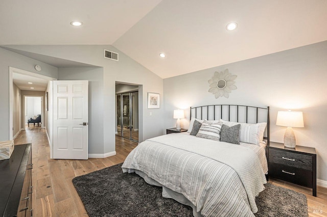 bedroom with lofted ceiling and light hardwood / wood-style flooring