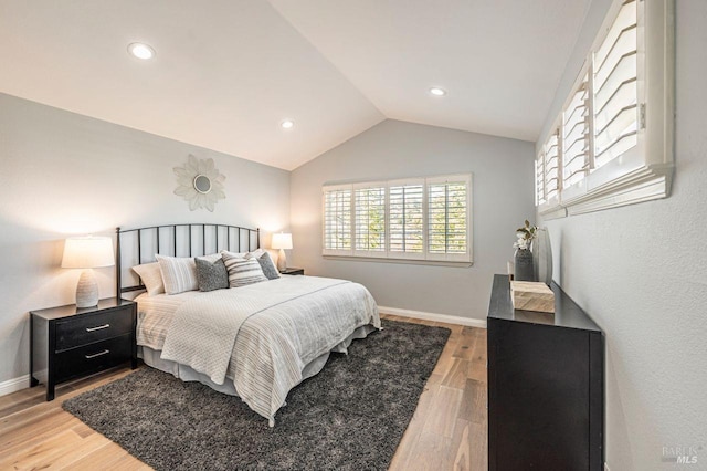 bedroom featuring vaulted ceiling and hardwood / wood-style flooring