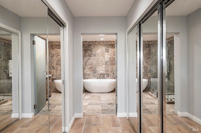 bathroom featuring toilet, tile walls, and plus walk in shower