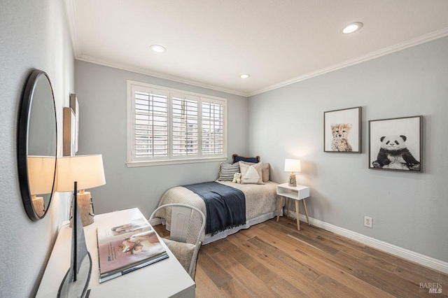 bedroom featuring fridge, ornamental molding, and hardwood / wood-style flooring