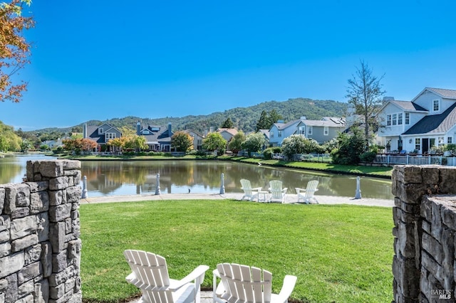 view of yard featuring a water and mountain view