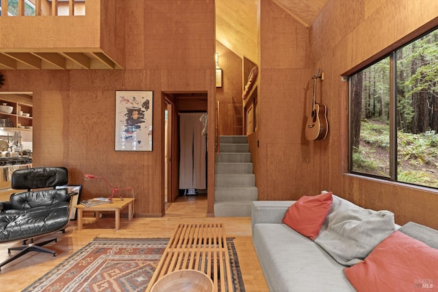 living room with hardwood / wood-style floors and wood walls