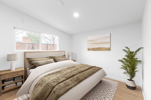 bedroom with recessed lighting, vaulted ceiling, baseboards, and wood finished floors