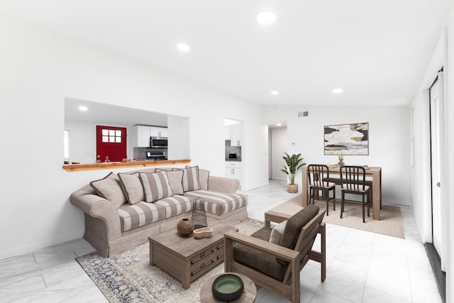 living room featuring vaulted ceiling, marble finish floor, visible vents, and recessed lighting