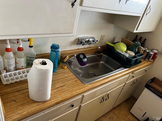 kitchen with sink and white cabinetry