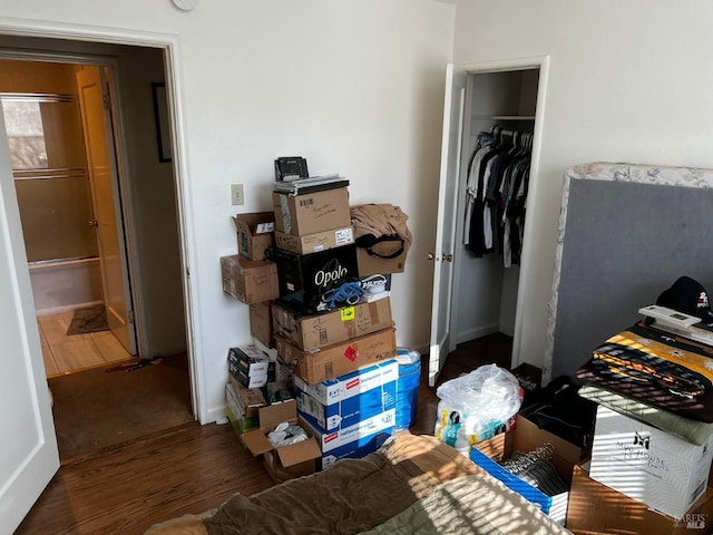 bedroom featuring a closet and dark hardwood / wood-style flooring