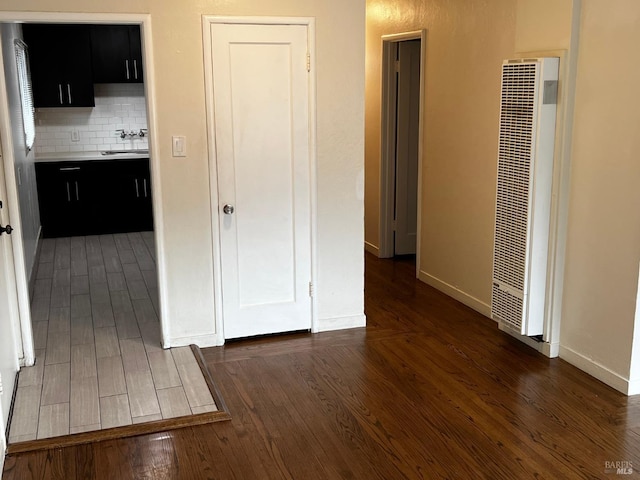 hallway featuring dark hardwood / wood-style flooring and sink