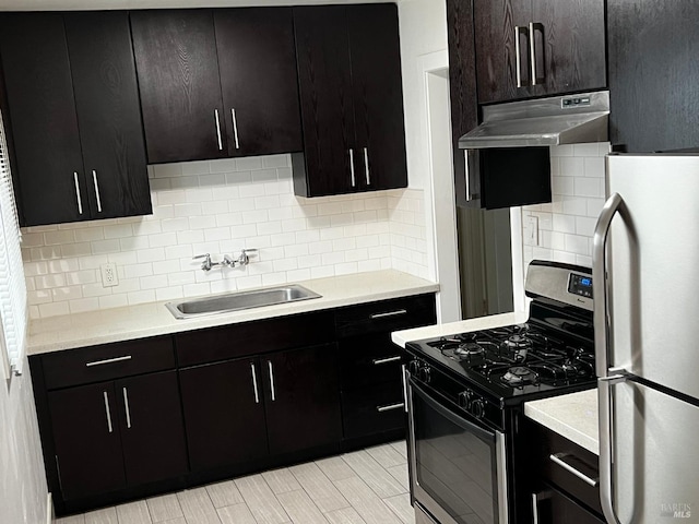 kitchen featuring decorative backsplash, dark brown cabinets, sink, and stainless steel appliances