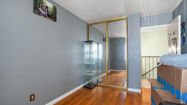 corridor with hardwood / wood-style floors