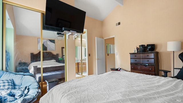 bedroom featuring vaulted ceiling with beams and a closet