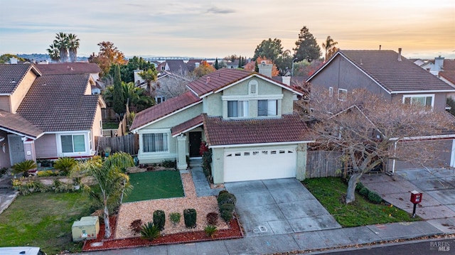 view of front of property with a garage and a yard