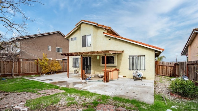 rear view of house featuring a pergola and a patio