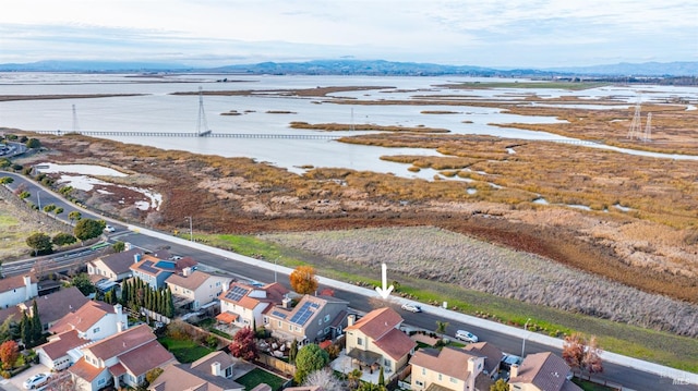 drone / aerial view with a water and mountain view