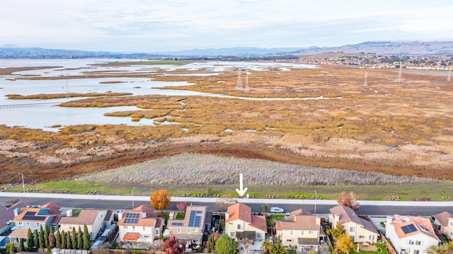 birds eye view of property featuring a water and mountain view