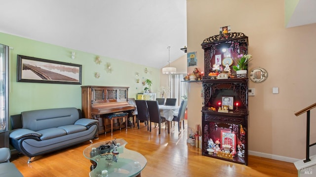 living room with wood-type flooring and vaulted ceiling