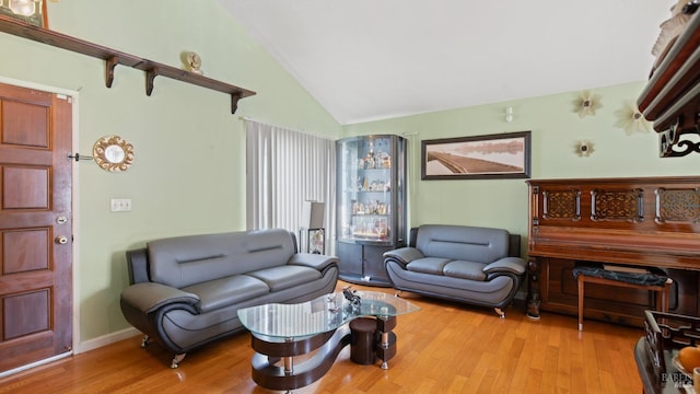 living room featuring light hardwood / wood-style flooring and lofted ceiling