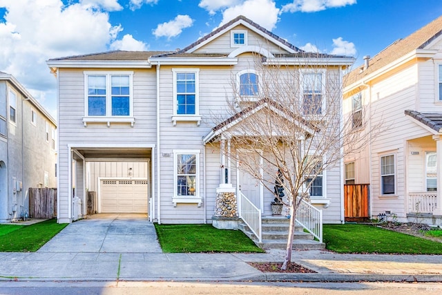 townhome / multi-family property with a front yard and a garage