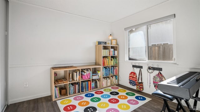 recreation room with dark hardwood / wood-style floors