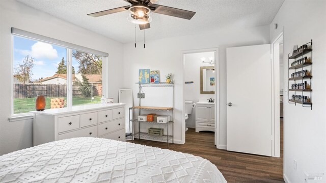 bedroom featuring a textured ceiling, connected bathroom, dark hardwood / wood-style floors, and ceiling fan