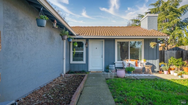 entrance to property with a lawn