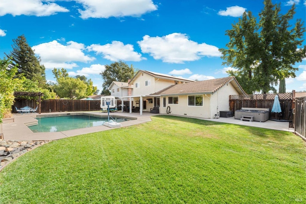 back of property featuring a hot tub, a fenced in pool, a patio, a fenced backyard, and stucco siding