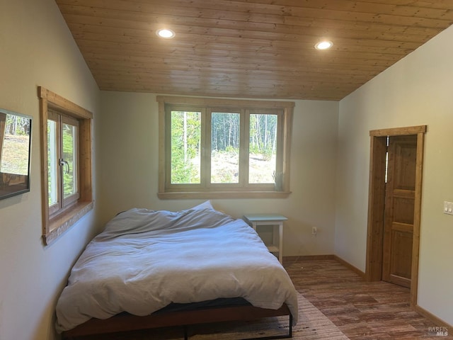 bedroom featuring lofted ceiling, wood-type flooring, and wood ceiling