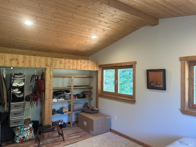 bedroom featuring carpet flooring, a closet, wood ceiling, and vaulted ceiling with beams