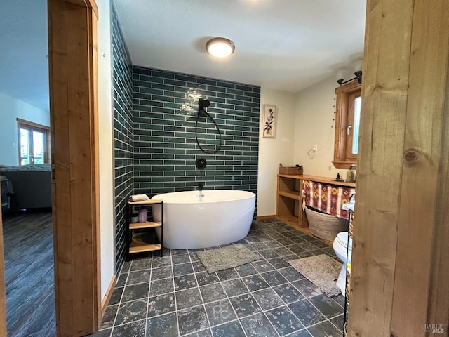 bathroom with toilet and a bathing tub