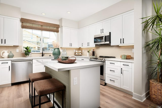 kitchen featuring white cabinetry, a center island, and stainless steel appliances