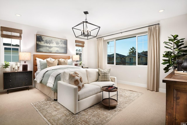 carpeted bedroom with a notable chandelier